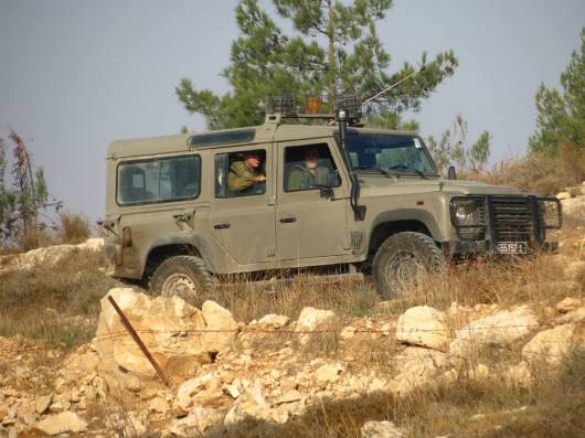Military Vehicle keeping a watch upon Palestinians plowing their lands, November 2013